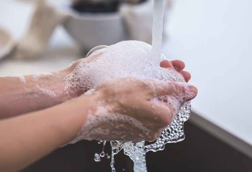 Person washing hands in a sink