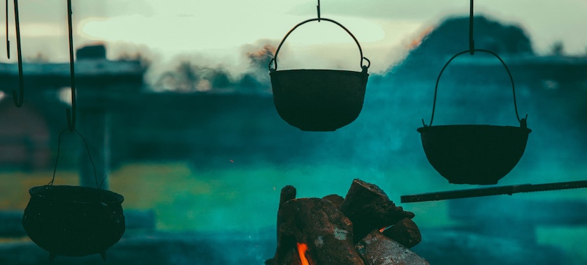 Picture of three cast iron pans hanging