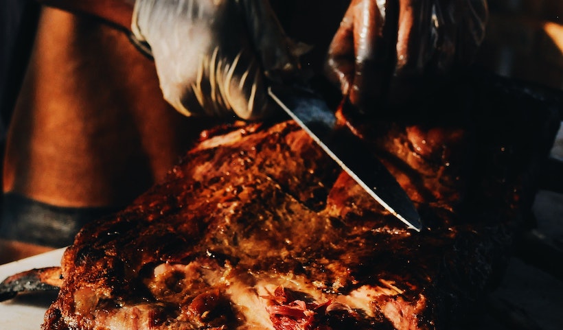 Barbecue dinner with a man slicing