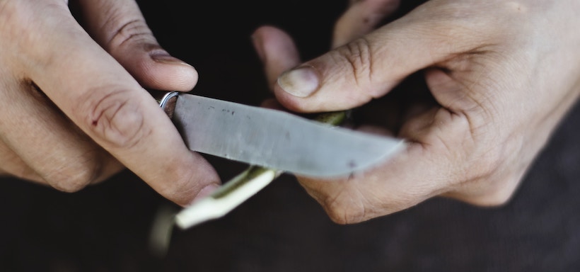 Man carving with knife