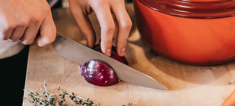 Slice red onion on a cutting board