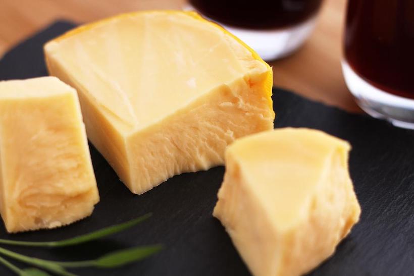 wine and cheese on a slate board