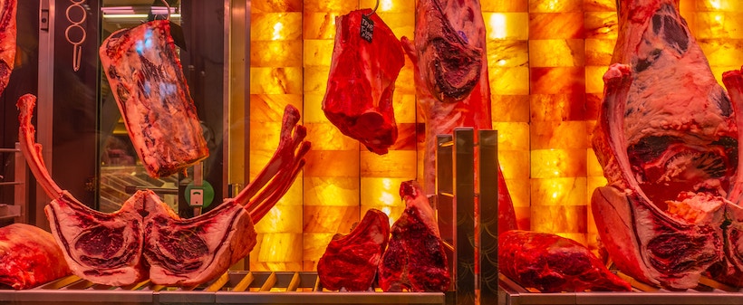 Hanging meat on display at a butcher's