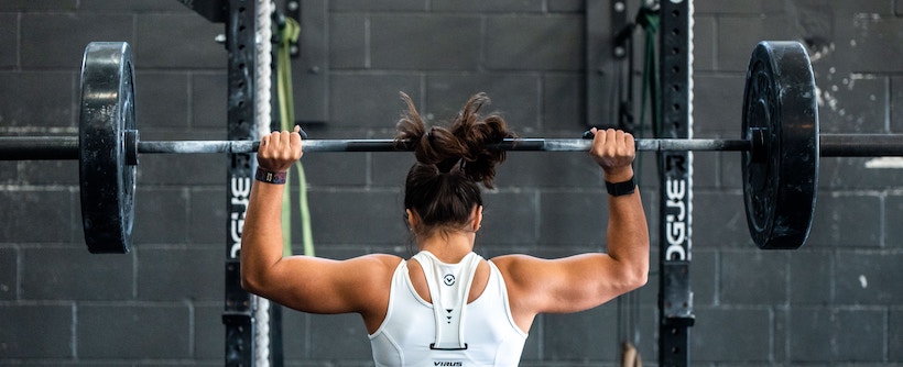 A lady does an overhead press