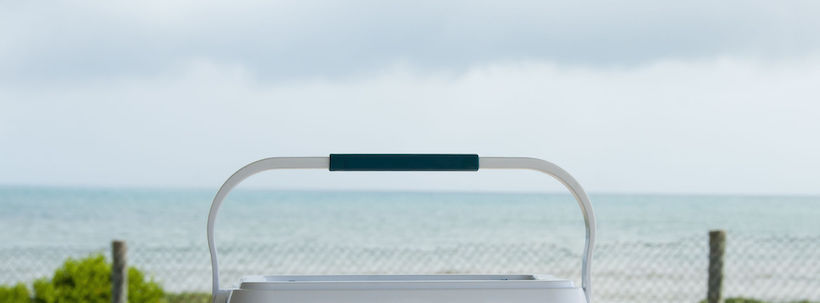 Handle of a cooler in front of the beach