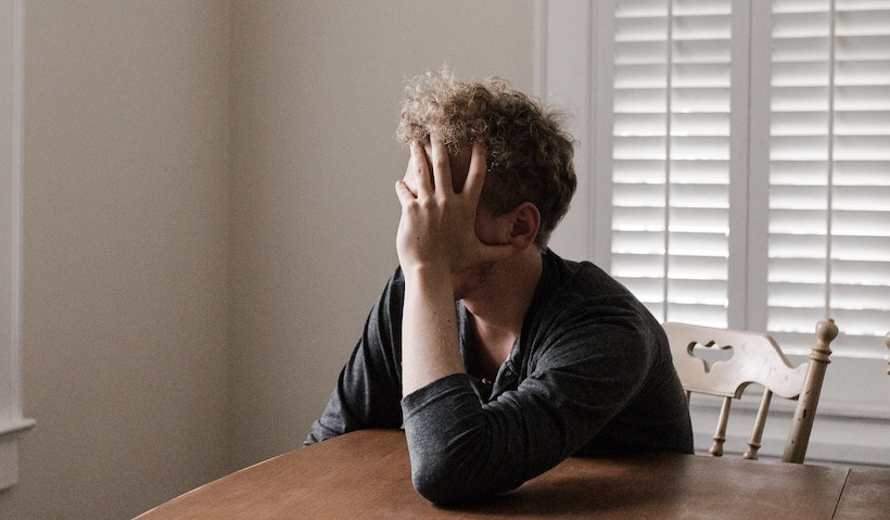 Man with anxiety holding head