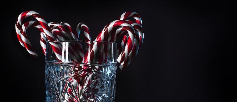 Crystal glass holding large candy canes 1/3s of image