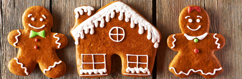 Christmas homemade gingerbread couple and house on wooden table