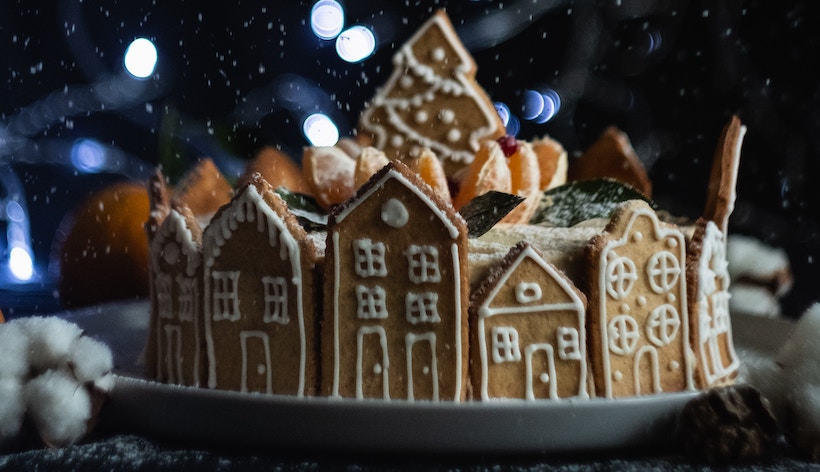 Gingerbread village with tree centerpiece and lights in back