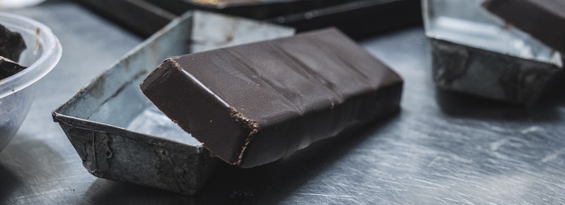 Dark chocolate bar on a metal table