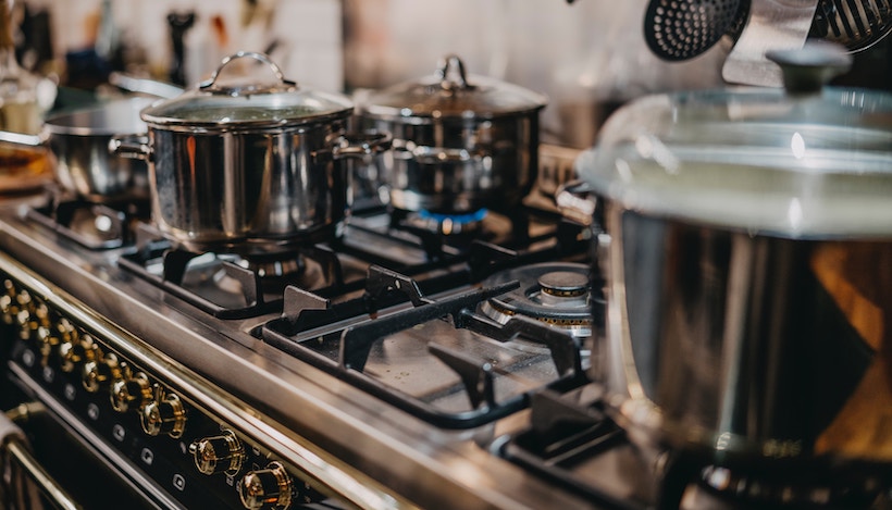 Stainless cookware on a stovetop