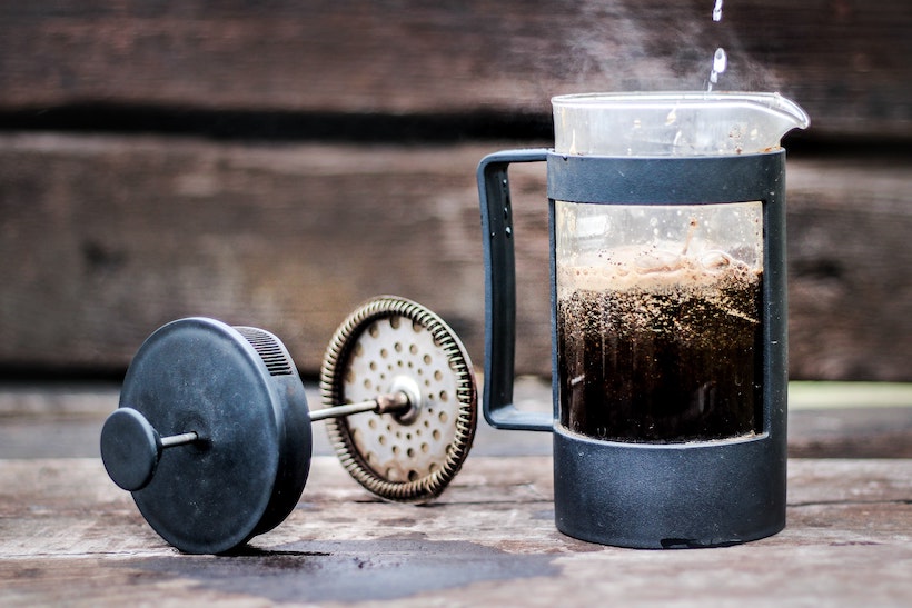 French press with coffee inside and deconstructed