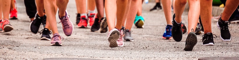 Calves, legs, and sneakers of a number of runners