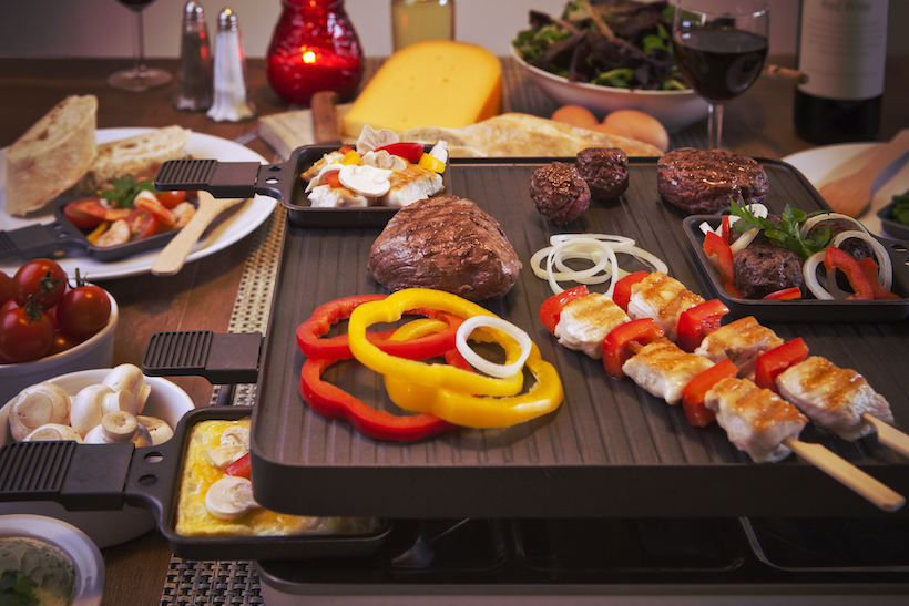 Swiss raclette grill with cooked meal on top