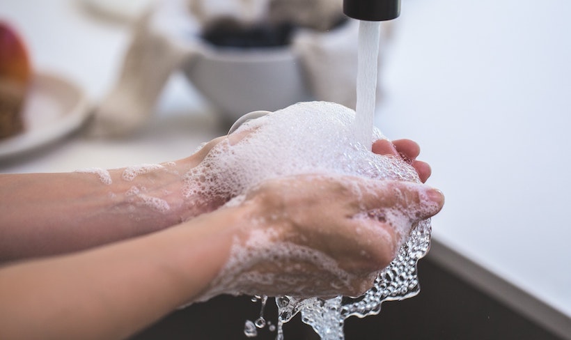 Person sudsing up hands to wash them
