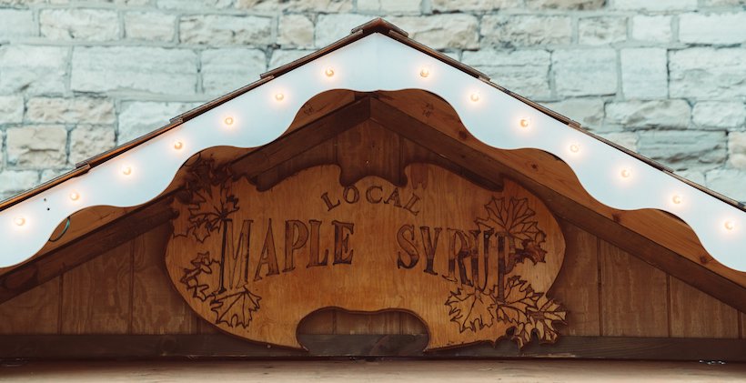 Wooden maple syrup sign above a door