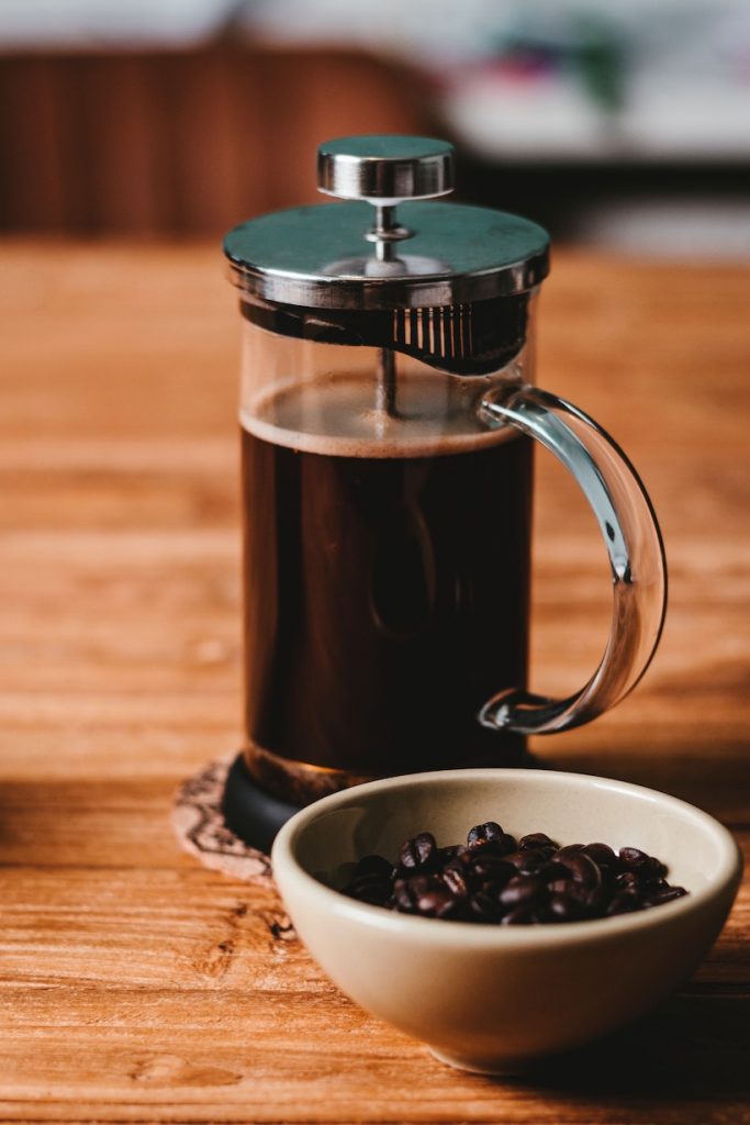 French press coffee next to beans