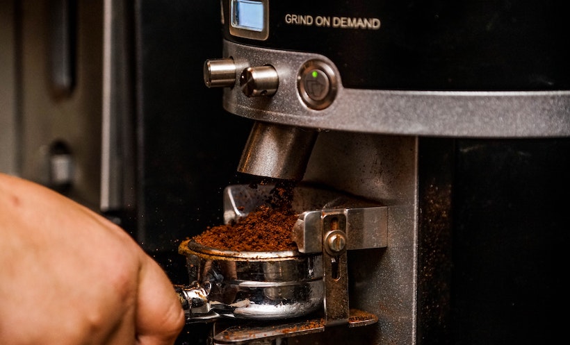 Grind on Demand Machine with coffee grounds