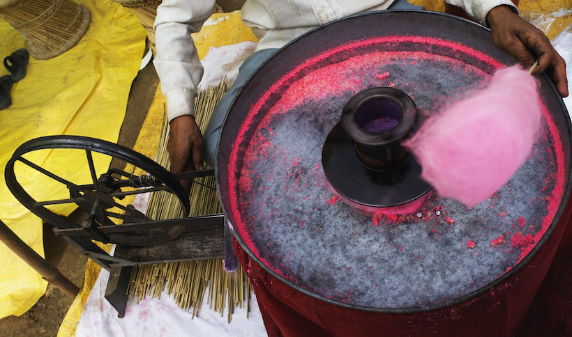 Vendor making pink cotton candy on his machine