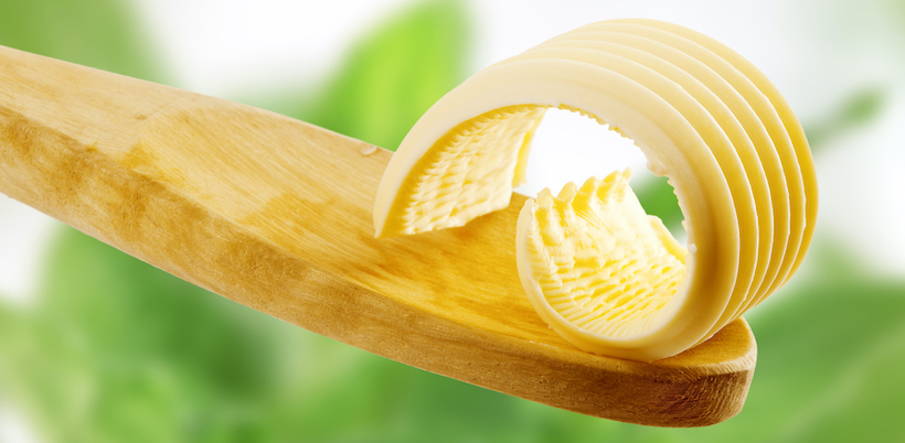 Butter curl on a wooden spoon - detail