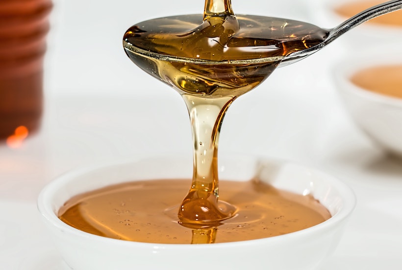 Honey Poured in Spoon to Bowl