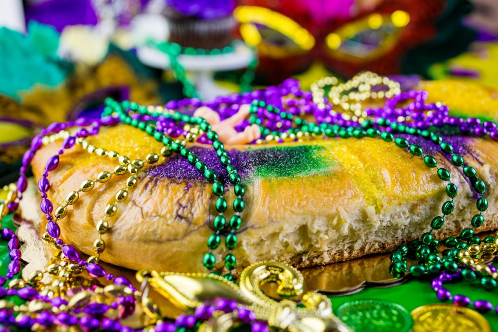 Decorated King Cake with plastic beads and coins