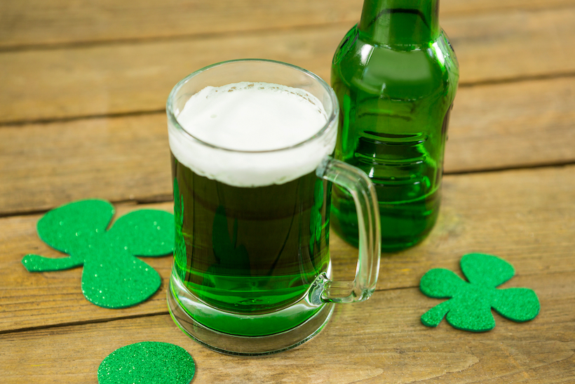 St Patricks Day green beer with shamrock on wooden surface